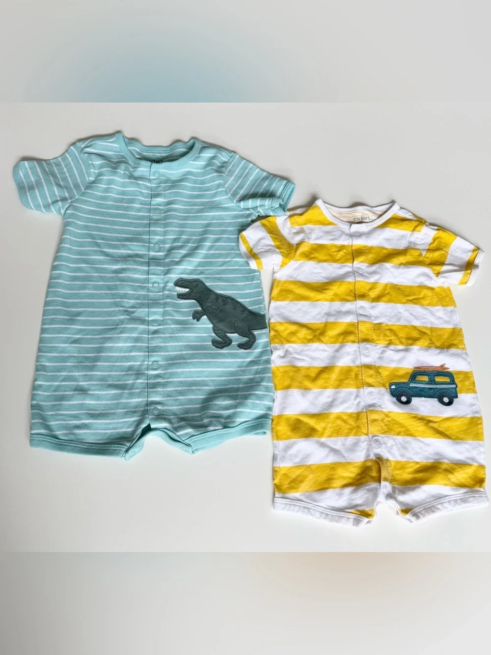Two Carter's rompers- Striped Dino & Yellow Striped Baby 24m